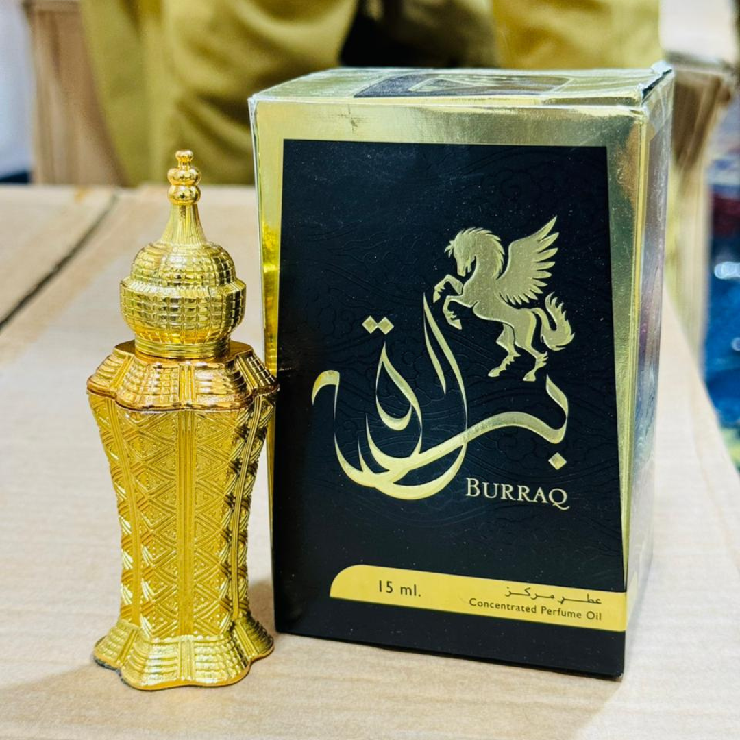 Gold perfume bottle and packaging with 'Burraq' branding on a wooden surface.