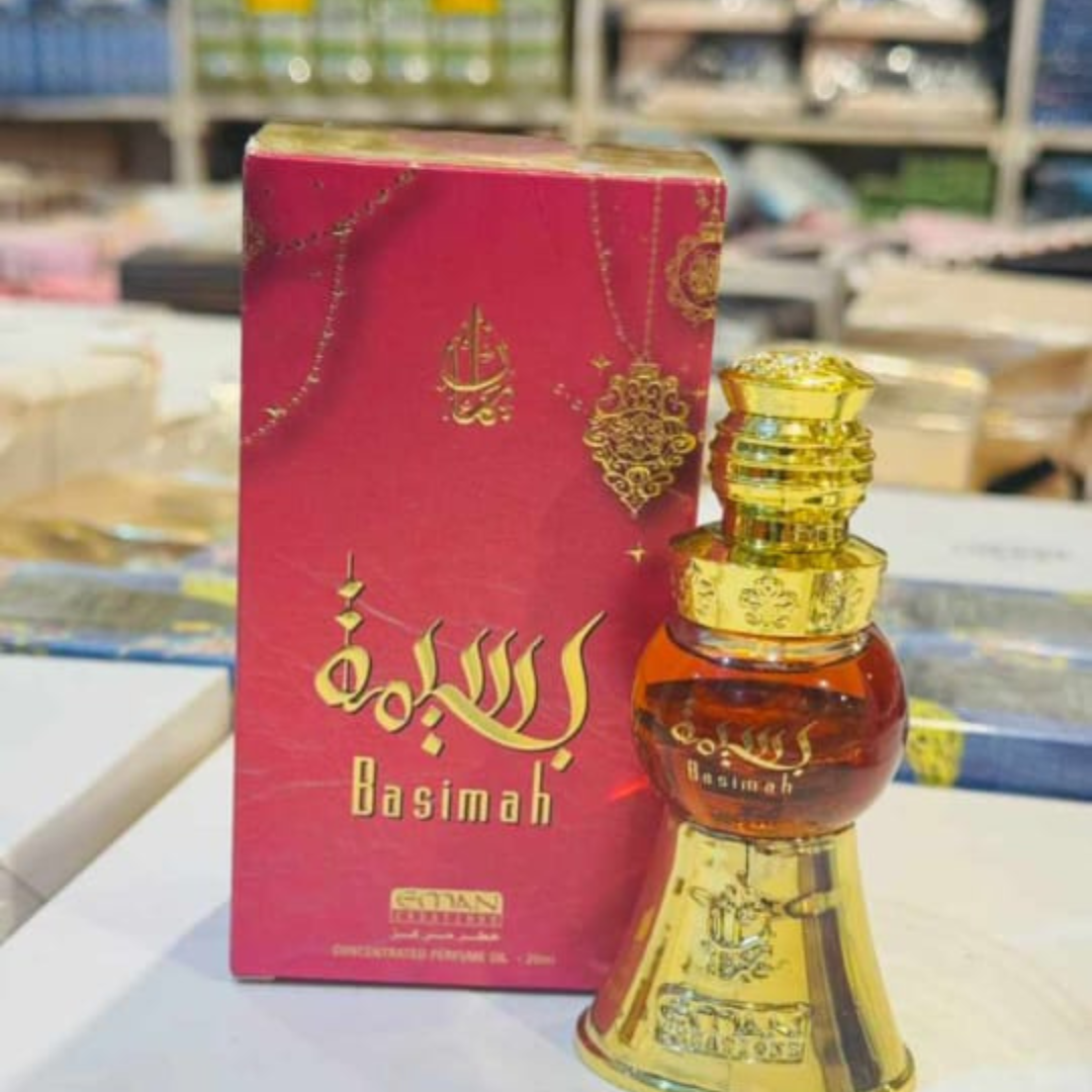 Gold and red Basimah perfume bottle with packaging on a blurred background
