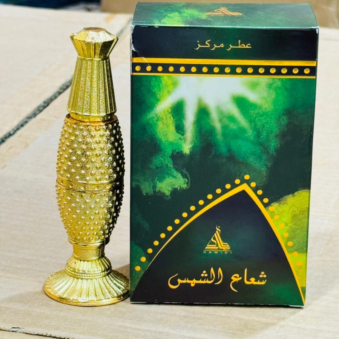 Gold perfume bottle and green box with Arabic text on a light background
