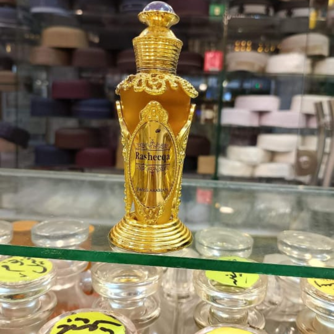 Gold ornate perfume bottle on a shelf with blurred background