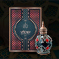 Decorative bottle and packaging with intricate design on a dark background