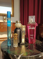 Collection of Shalis perfume bottles on a table with a blurred background