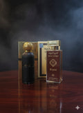 Amber Al Baid perfume bottle and packaging on a wooden surface with a dark background