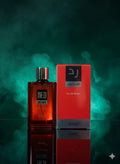 Perfume bottle and packaging with 'D'J' branding on a dark background